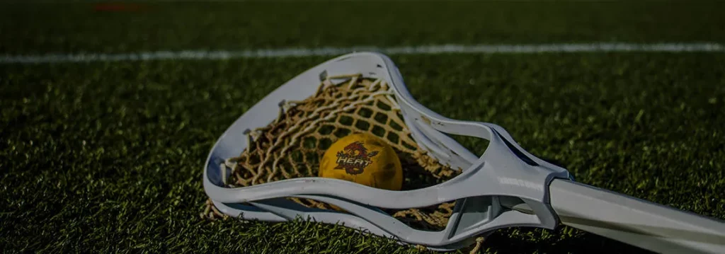 heat lacrosse ball on field in lacrosse stick